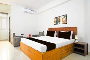 a bedroom with a large bed in a room at Super Collection O Raja Bazar Bailey Road in Patna