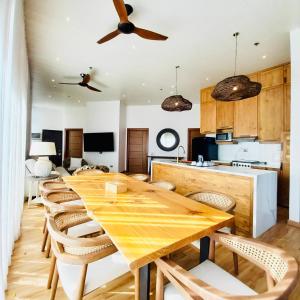 a kitchen and dining room with a wooden table and chairs at Summer in Lapu Lapu City