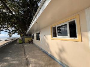 a building with two windows on the side of it at Ellen Homestay in San Juan