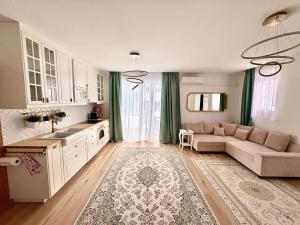a living room with a couch and a kitchen at Libás Apartman in Keszthely