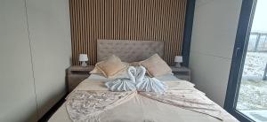 a bed with two pillows on it in a bedroom at DuoDomkyTa3 in Spišská Belá