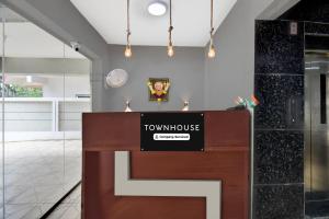 a podium in a lobby with a townhouse sign on it at Super Townhouse Pimple Nilakh Pune in Dāpuri