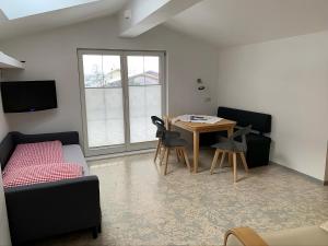 a living room with a bed and a table and chairs at Sonnenappartement in Mayrhofen