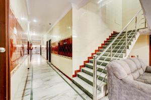 a staircase with green and red stairs in a building at Collection O Vadapalani Formerly Mahalakshmi Inn in Chennai +39 photos