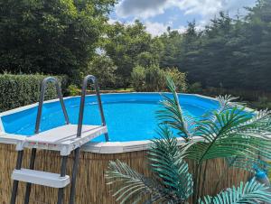 a white chair sitting next to a swimming pool at Ferienwohnung Nico in Stadtilm