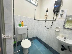a bathroom with a shower and a toilet and a sink at Homestay 3U MU5L1M Only in Cukai