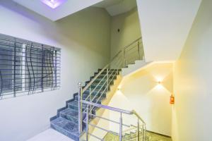 a staircase in a building with a blue stair case at Collection O Ujjain City Centre Formerly Hotel Olive Inn in Ujjain