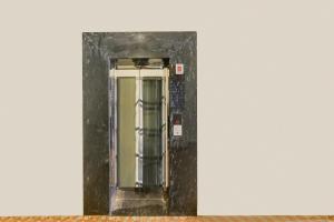 an elevator in a black frame on a wall at Collection O Ujjain City Centre Formerly Hotel Olive Inn in Ujjain +38 photos