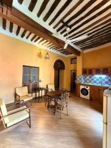a large living room with a table and chairs at Arizona apartment in Zanzibar City
