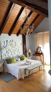 a bedroom with a bed and a chandelier at Casa Santiago in Argoños