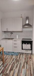 a kitchen with white cabinets and a sink at Dreams in Pisa