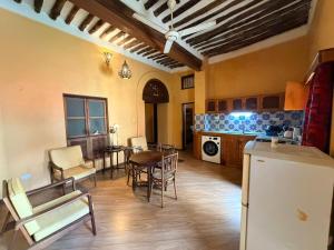 a kitchen and living room with a table and chairs at Arizona apartment in Zanzibar City