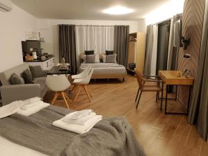 a bedroom with two beds and a living room at Rafina Studio apartments kondilia in Rafina