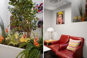 a living room with a red chair and flowers at City Hostel in Stockholm