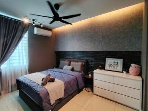 a bedroom with a bed and a ceiling fan at Ipoh Meru 3 Bedroom Suites by IWH Suites in Ipoh