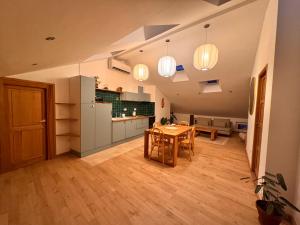 a kitchen and a dining room with a table at Confort et élégance au cœur de Florac in Florac
