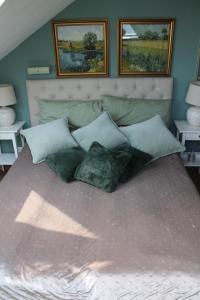 a bed with a bunch of pillows on it at Hideaway Palais Auersperg in Salzburg