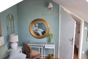 a living room with a mirror and a chair at Hideaway Palais Auersperg in Salzburg +3 photos