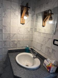 a bathroom sink with two lights on a counter at Zalooma House I Beachfront Hostel Dahab in Dahab +54 photos