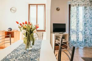 a vase of flowers on a table in a living room at Appartamento Ortensia - Meina in Meina