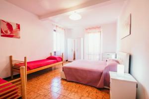 a bedroom with a bed and a couch in it at Appartamento Ortensia - Meina in Meina +17 photos