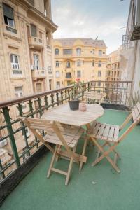 a wooden table and chairs on a balcony at Rhala Hostel Egypt in Cairo