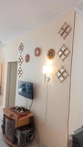 a room with a desk and a wall with star decorations at Villa Highland 9O Berastagi View in Berastagi