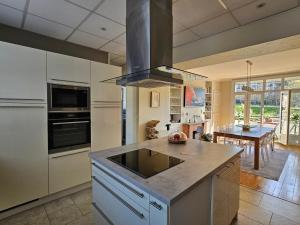 a kitchen with white cabinets and a counter top at La Roseraie in Le Mans
