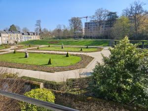 a park with a garden with trees and grass at La Roseraie in Le Mans