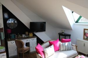 a living room with a white couch with pink pillows at Hideaway Palais Auersperg in Salzburg