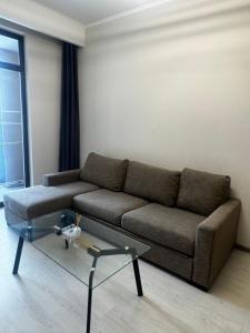 a living room with a couch and a glass coffee table at Alvina Complex in Tsaghkadzor