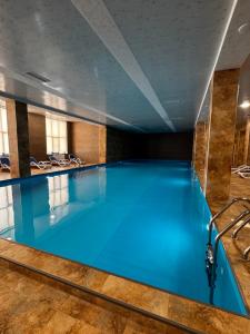 a large swimming pool with blue water at Alvina Complex in Tsaghkadzor