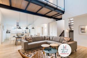 a living room with a couch and a table at Marissa Resort in Lembruch