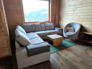 a living room with a couch and a chair at Bergliebe Klippitztörl in Klippitztorl