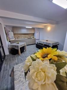 a kitchen with a large yellow flower on the floor at Popasul Ursului Zărnești in Zărneşti +32 photos