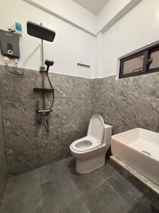 a bathroom with a toilet and a sink at Perrera Guesthouse in Santa Ana