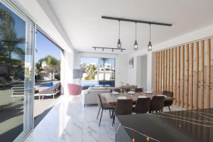 a dining room and living room with a table and chairs at Vie Bleu Villas in Protaras