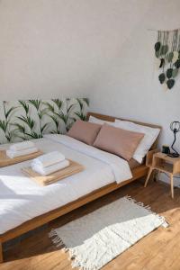 a bed with two pillows on it in a room at Silvarium Kaszuby Domek Sosna in Stężyca