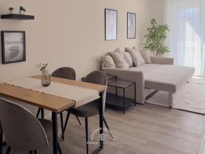 a living room with a couch and a table at Ruppiner Seeblick Ferienwohnungen in Neuruppin