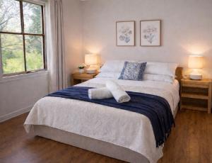 a bedroom with a large bed with two night stands at Balingup Highview Chalets in Balingup