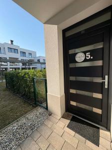 a black garage door with the number on it at H&H Apartman in Fonyód +3 photos