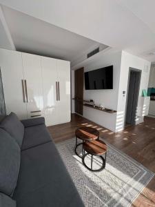 a living room with a couch and a table at H&H Apartman in Fonyód