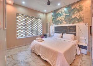 a bedroom with a large bed with a large painting on the wall at Hill Breeze Pool Resort Vagamon by VOYE HOMES in Vagamon +44 photos