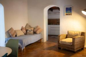 a living room with a couch and a chair at Casa Piscina Casa Principal in Artá