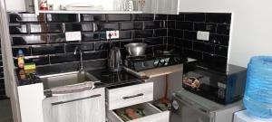 a kitchen with a sink and a stove at Starla, Duplex in Nairobi