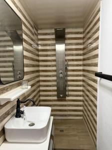 a bathroom with a sink and a mirror at GuestHouse Mendrika in Talata-maty