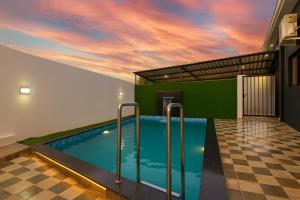 a swimming pool mural in a house with a sunset at JAGUAR VILLA II 3BHK II AC II POOL Il EMPYREAN STAY in Lonavala