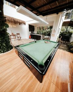 a pool table in the middle of a room at Balay nimo by Sachzna in Amadeo