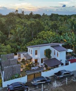 an aerial view of a house with two cars parked in front at Balay nimo by Sachzna in Amadeo