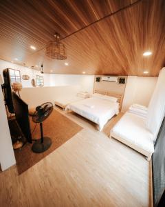 a room with two beds and a desk in it at Balay nimo by Sachzna in Amadeo +25 photos